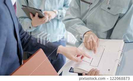 A man in work clothes having a meeting with a client A man in work clothes having a meeting with a client 122068873