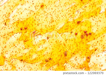 Close up of honeycomb with golden honey drizzle and pollen granules creating 122069370