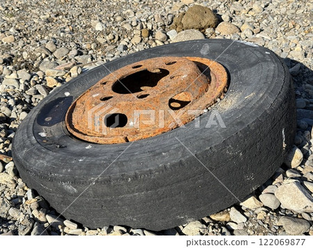Used tires discarded on the riverbank Used tires discarded on the riverbank 122069877