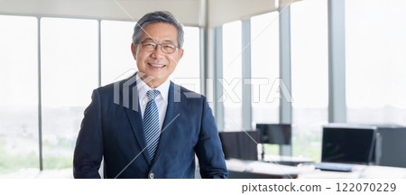 在辦公室拍攝的 50 多歲或 60 多歲的微笑商人的肖像 122070229