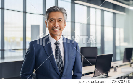 Portrait of a smiling businessman in his 50s or 60s photographed in an office 122070238