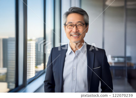 Portrait of a smiling businessman in his 50s or 60s photographed in an office Portrait of a smiling businessman in his 50s or 60s photographed in an office 122070239