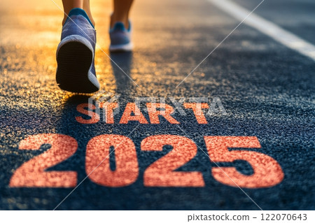 Running towards the start of 2025 on a sunlit track. Running towards the start of 2025 on a sunlit track. 122070643