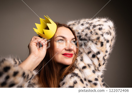 A Confident Woman Adorned with a Crown, Dressed in a Fashionable and Stylish Outfit 122072406