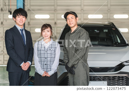 Male and female employees in the pit of a repair shop (auto repair shop, private vehicle inspection center, staff) Male and female employees in the pit of a repair shop (auto repair shop, private vehicle inspection center, staff) 122073475