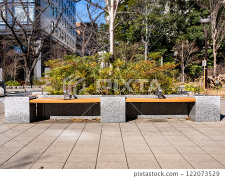 A bench with a partition in the park A bench with a partition in the park 122073529