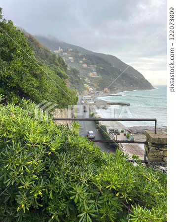Moneglia, Italy - 09 January 2025. Old park by sea. Overcast weather, fog. Plant and tree. Stone wall, building in Italy. Municipality of Moneglia, Liguria region. View from mountain.  122073809