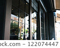 Buildings reflected in the retro glass windows of a fashionable store 122074447