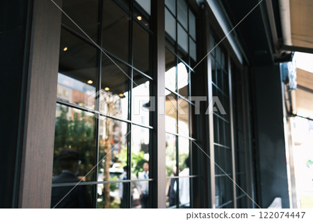 Buildings reflected in the retro glass windows of a fashionable store 122074447