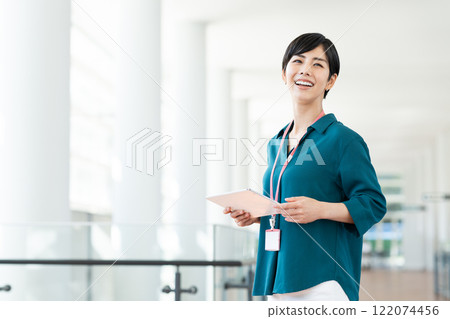 Businesswoman using a tablet in the office Businesswoman using a tablet in the office 122074456