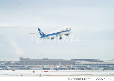 New Chitose Airport in winter: Snow smoke and planes taking off, Chitose, Hokkaido 122075289
