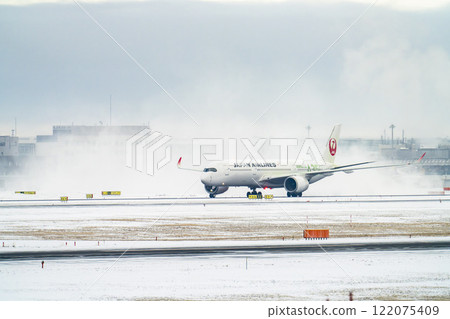 New Chitose Airport in winter: Snow smoke and taxiing airplanes, Chitose, Hokkaido 122075409