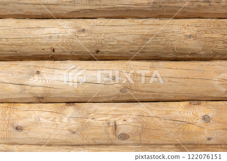 New wooden wall made of uncolored natural pine tree logs, front view New wooden wall made of uncolored natural pine tree logs, front view 122076151