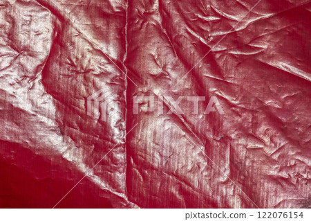 Shiny red frontlit of an old crumped banner, abstract background photo 122076154