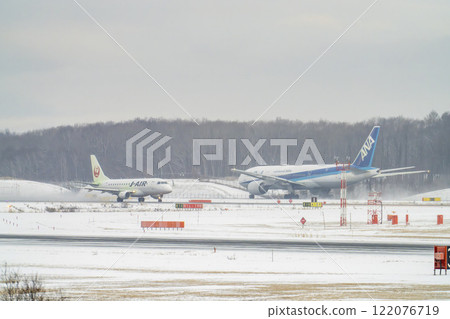New Chitose Airport in winter: Snow smoke and planes taking off, Chitose, Hokkaido New Chitose Airport in winter: Snow smoke and planes taking off, Chitose, Hokkaido 122076719