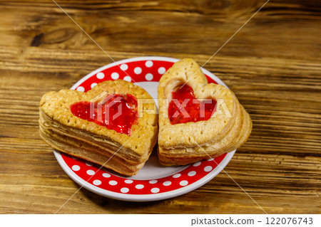 Heart shaped puff cookies with jam on a wooden table. Dessert on Valentine`s Day 122076743