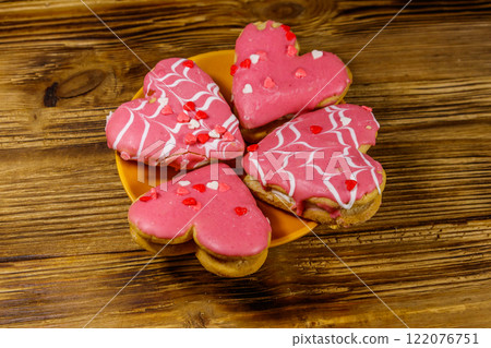 Heart shaped cookies on wooden table. Dessert for Valentine day Heart shaped cookies on wooden table. Dessert for Valentine day 122076751