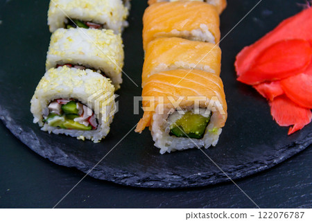 Set of sushi rolls on a black stone slate Set of sushi rolls on a black stone slate 122076787