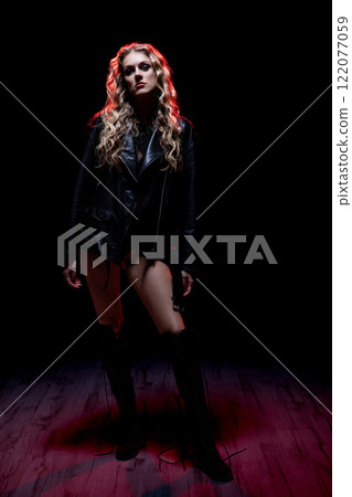 A Dramatic Fashion Portrait Captured in Dim and Atmospheric Lighting for Creative Depth A Dramatic Fashion Portrait Captured in Dim and Atmospheric Lighting for Creative Depth 122077059