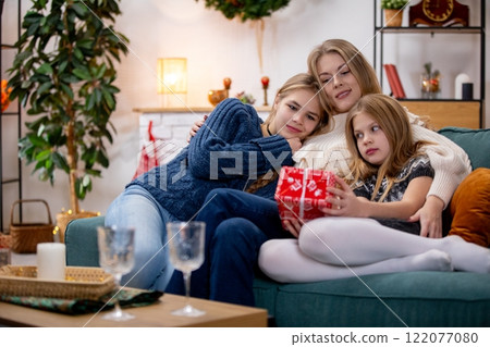 A Cozy Family Gathering Filled with Delightful Holiday Gifts and Cheerful Moments Together 122077080