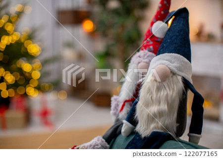 A beautiful Decorative Christmas Figurine featuring a charming Tree Background setting A beautiful Decorative Christmas Figurine featuring a charming Tree Background setting 122077165