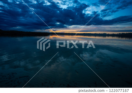 A Serene Twilight Over Reflective Waters Within a Beautiful and Tranquil Landscape Setting A Serene Twilight Over Reflective Waters Within a Beautiful and Tranquil Landscape Setting 122077187