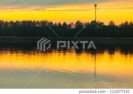A Majestic and Stunning Sunset Reflection Over the Calm Waters of Natures Beauty A Majestic and Stunning Sunset Reflection Over the Calm Waters of Natures Beauty 122077191