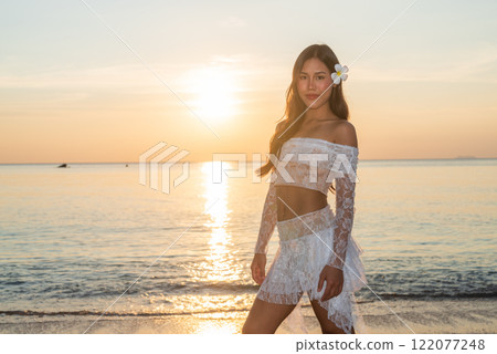 Beautiful Young Thai Woman at Tropical Beach During Sunset Beautiful Young Thai Woman at Tropical Beach During Sunset 122077248