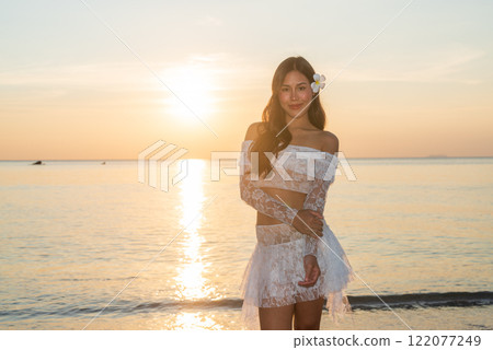 Beautiful Young Thai Woman at Tropical Beach During Sunset Beautiful Young Thai Woman at Tropical Beach During Sunset 122077249