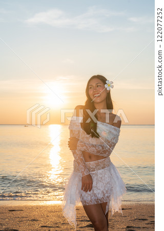 Beautiful Young Thai Woman at Tropical Beach During Sunset 122077252