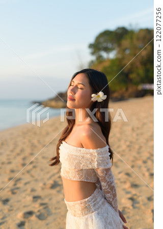 Beautiful Young Thai Woman at Tropical Beach During Sunset 122077256