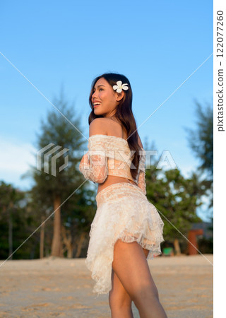 Beautiful Young Thai Woman at Tropical Beach During Sunset Beautiful Young Thai Woman at Tropical Beach During Sunset 122077260