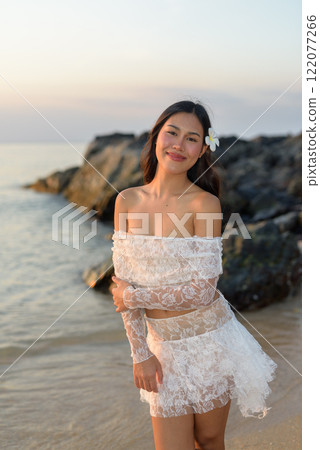 Beautiful Young Thai Woman at Tropical Beach During Sunset 122077266