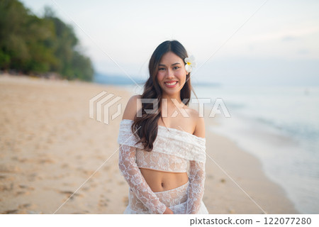 Beautiful Young Thai Woman at Tropical Beach During Sunset Beautiful Young Thai Woman at Tropical Beach During Sunset 122077280