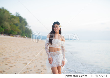 Beautiful Young Thai Woman at Tropical Beach During Sunset 122077281