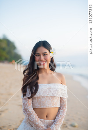Beautiful Young Thai Woman at Tropical Beach During Sunset 122077283