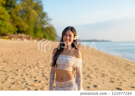 Golden Hour Beauty Asian Woman Enjoying Peaceful Sunset at the Beach Golden Hour Beauty Asian Woman Enjoying Peaceful Sunset at the Beach 122077284