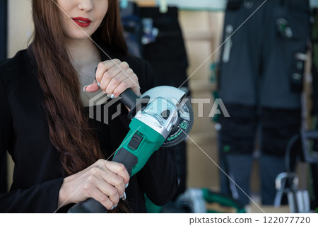 A confident woman holds a modern tool in a stylish setting, embodying contemporary design A confident woman holds a modern tool in a stylish setting, embodying contemporary design 122077720