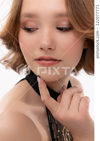 An Elegant Young Woman Featuring a Stylish Makeup Look and Beautifully Styled Hairstyle An Elegant Young Woman Featuring a Stylish Makeup Look and Beautifully Styled Hairstyle 122077771