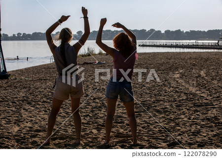 Experience the Joyful Dance by the Water Embrace the Pure Bliss of Summer Fun and Laughter 122078290