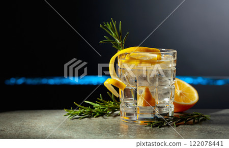 Refreshing gin-tonic cocktail with lemon and rosemary. Refreshing gin-tonic cocktail with lemon and rosemary. 122078441