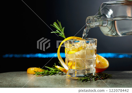 Refreshing gin-tonic cocktail with lemon and rosemary. Refreshing gin-tonic cocktail with lemon and rosemary. 122078442