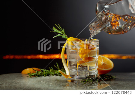 Refreshing gin-tonic cocktail with lemon and rosemary. Refreshing gin-tonic cocktail with lemon and rosemary. 122078443