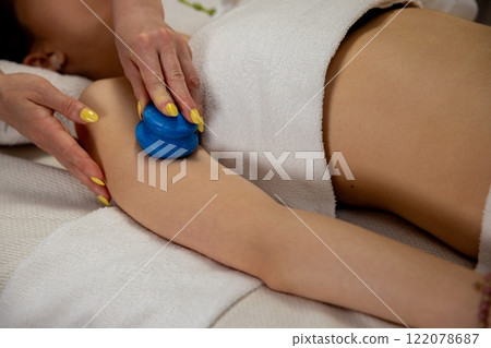 Indulge in a Relaxing Massage Therapy Experience Enhanced with the Cupping Technique 122078687