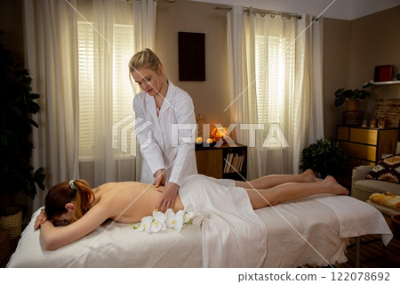 Experience the soothing relaxation of massage therapy in a serene and calm spa environment Experience the soothing relaxation of massage therapy in a serene and calm spa environment 122078692