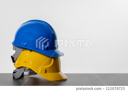 A Vibrant Array of Colorful Construction Helmets Neatly Stacked on a Countertop Surface A Vibrant Array of Colorful Construction Helmets Neatly Stacked on a Countertop Surface 122078725