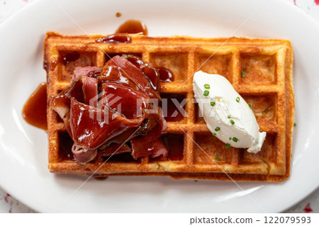 Portion of waffle with brisket and cream cheese 122079593