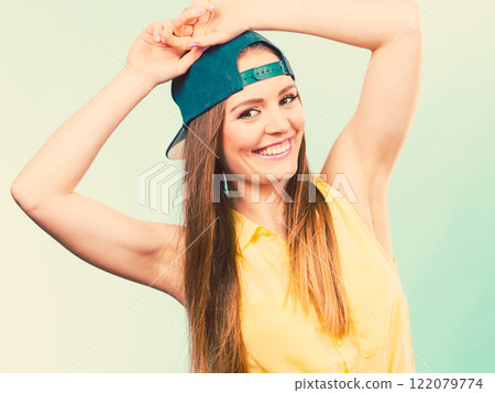 Woman casual style cap on head on blue. Fashion shot Woman casual style cap on head on blue. Fashion shot 122079774