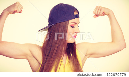 Woman casual style showing off muscles biceps Woman casual style showing off muscles biceps 122079779