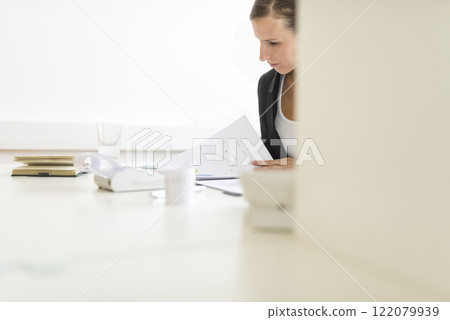 View around a partition of a woman in an office View around a partition of a woman in an office 122079939